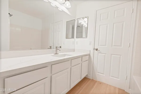 a white toilet sitting next to a white wall