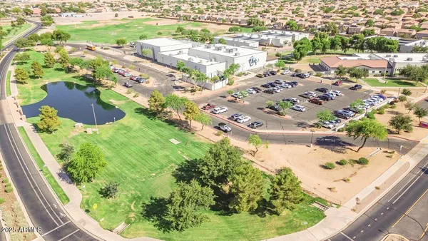 an aerial view of residential houses with outdoor space and ocean view