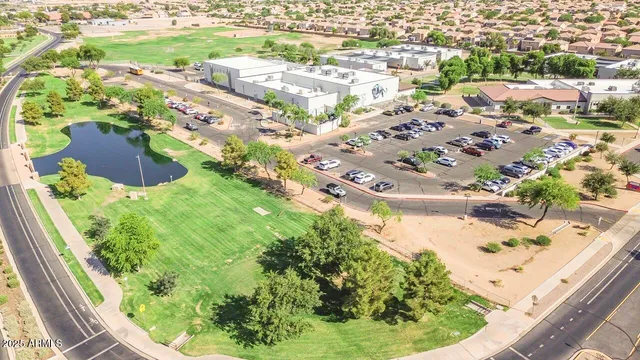 an aerial view of residential houses with outdoor space and ocean view