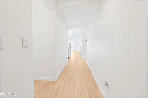 a view of a hallway with wooden floor