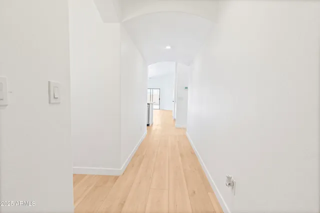 a view of a hallway with wooden floor