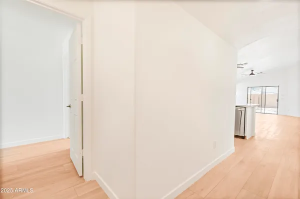a view of a hallway with wooden floor and entryway