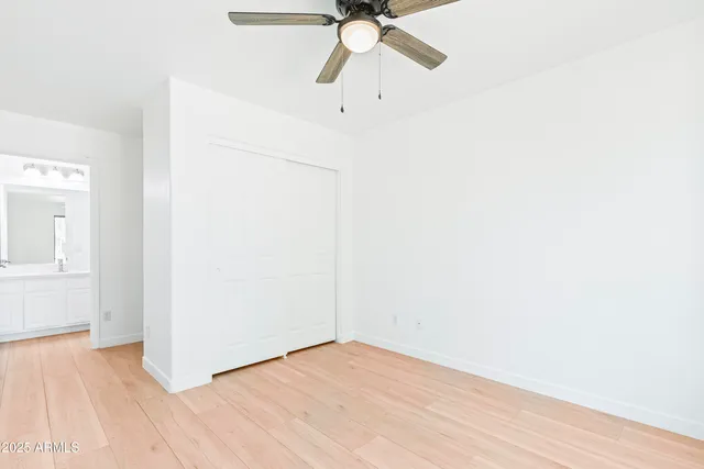 a kitchen with kitchen island white cabinets and stainless steel appliances