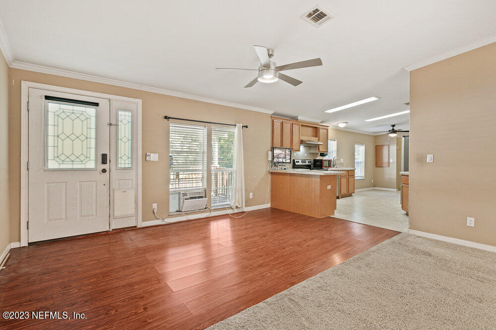 18066 Wells Road Jacksonville, FL 32234 - Photo 11 of 50 a view of a kitchen with a stove cabinets and wooden floor