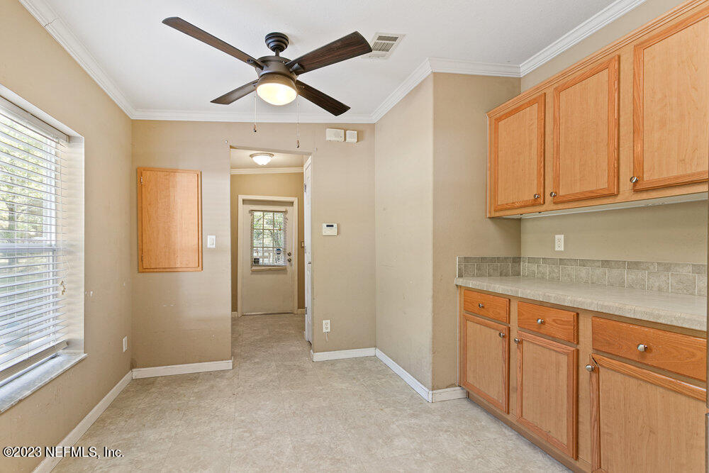 18066 Wells Road Jacksonville, FL 32234 - Photo 14 of 50 an empty room with fan and windows