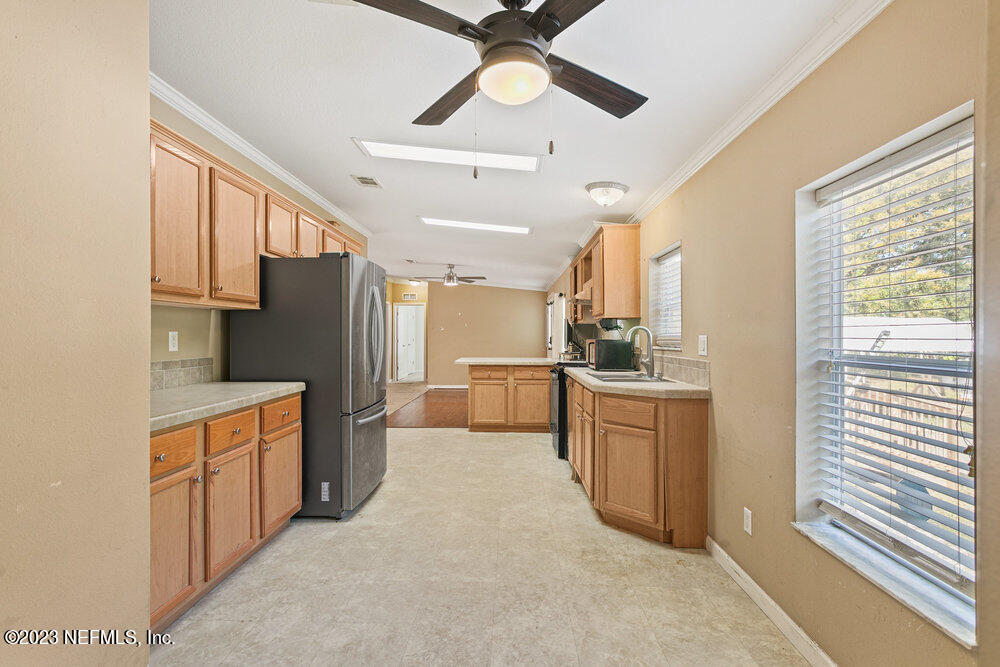 18066 Wells Road Jacksonville, FL 32234 - Photo 17 of 50 a kitchen with stainless steel appliances a refrigerator sink and stove