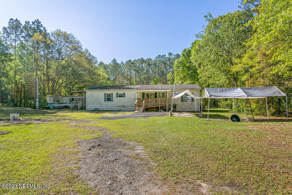 18066 Wells Road Jacksonville, FL 32234 - Photo 2 of 50 a view of a house with backyard and swimming pool