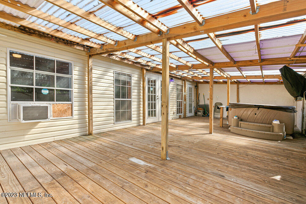 18066 Wells Road Jacksonville, FL 32234 - Photo 23 of 50 a view of a room with wooden floor and windows