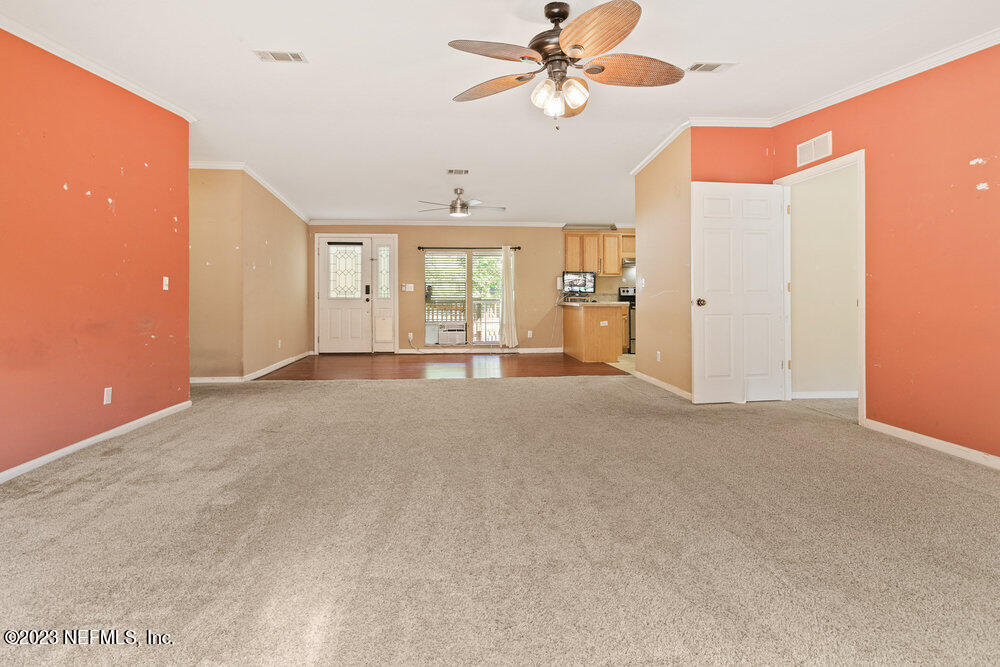 18066 Wells Road Jacksonville, FL 32234 - Photo 24 of 50 a view of a livingroom with a chandelier fan and windows