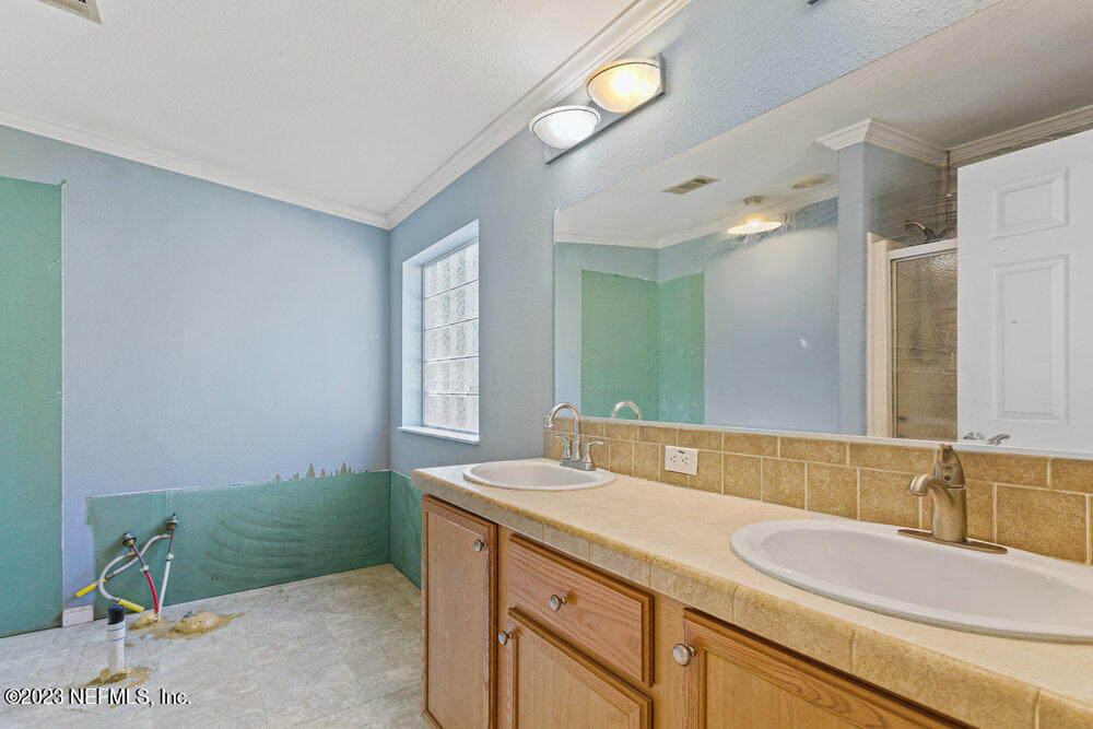 18066 Wells Road Jacksonville, FL 32234 - Photo 27 of 50 a bathroom with a sink and a mirror