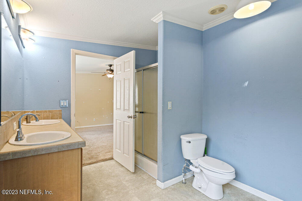 18066 Wells Road Jacksonville, FL 32234 - Photo 28 of 50 a bathroom with a sink toilet and shower