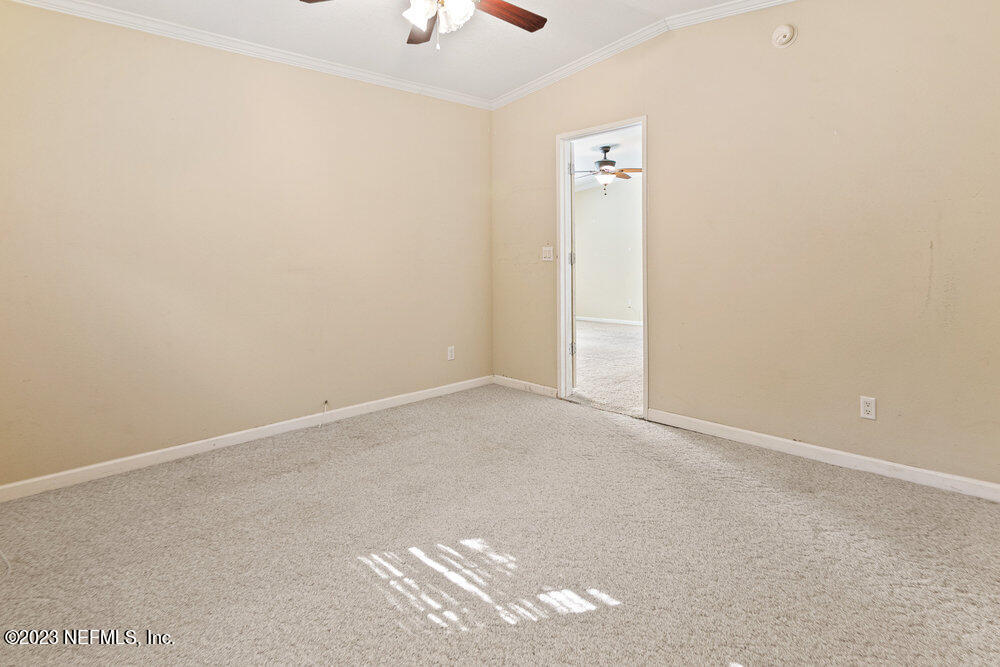 18066 Wells Road Jacksonville, FL 32234 - Photo 30 of 50 an empty room with a ceiling fan and window