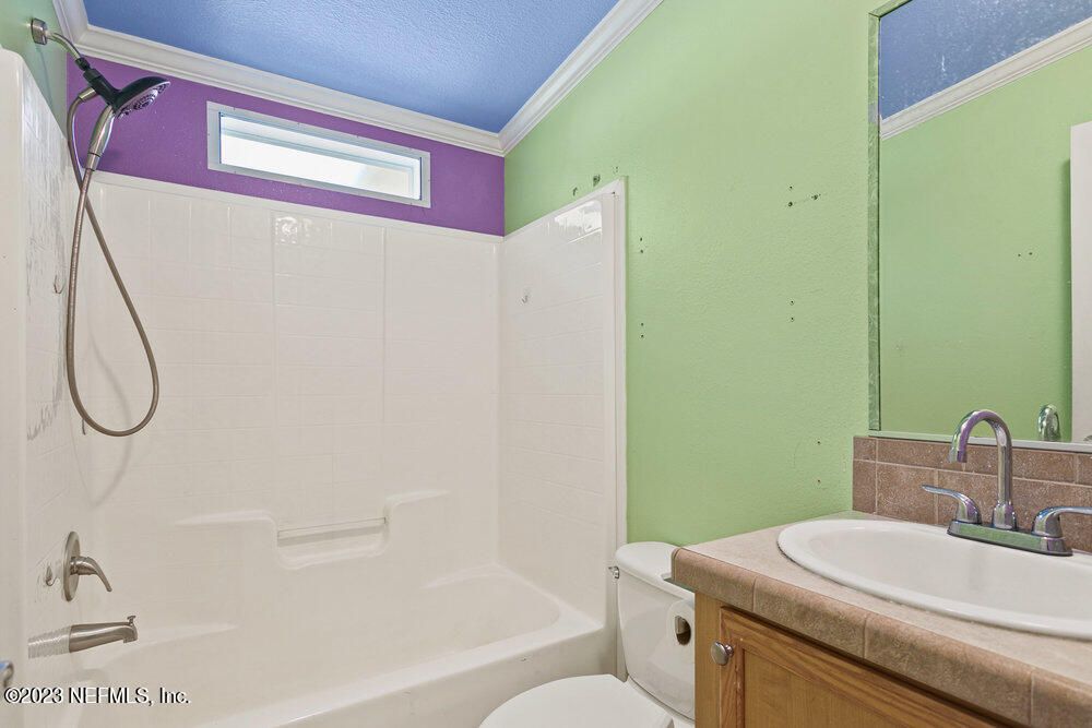 18066 Wells Road Jacksonville, FL 32234 - Photo 31 of 50 a bathroom with a sink toilet and shower