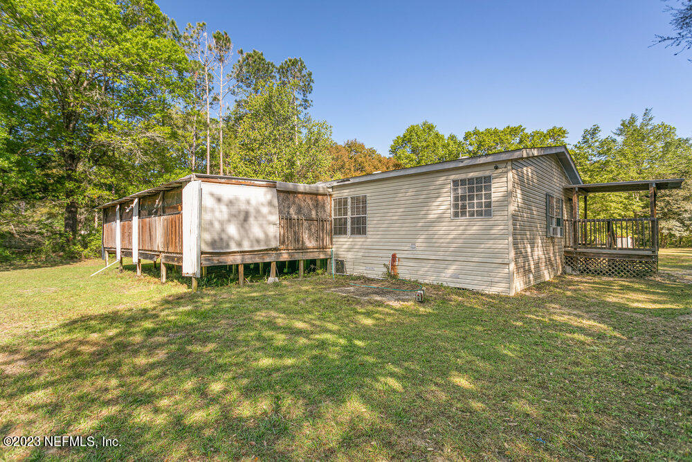 18066 Wells Road Jacksonville, FL 32234 - Photo 36 of 50 a backyard of a house with table and chairs