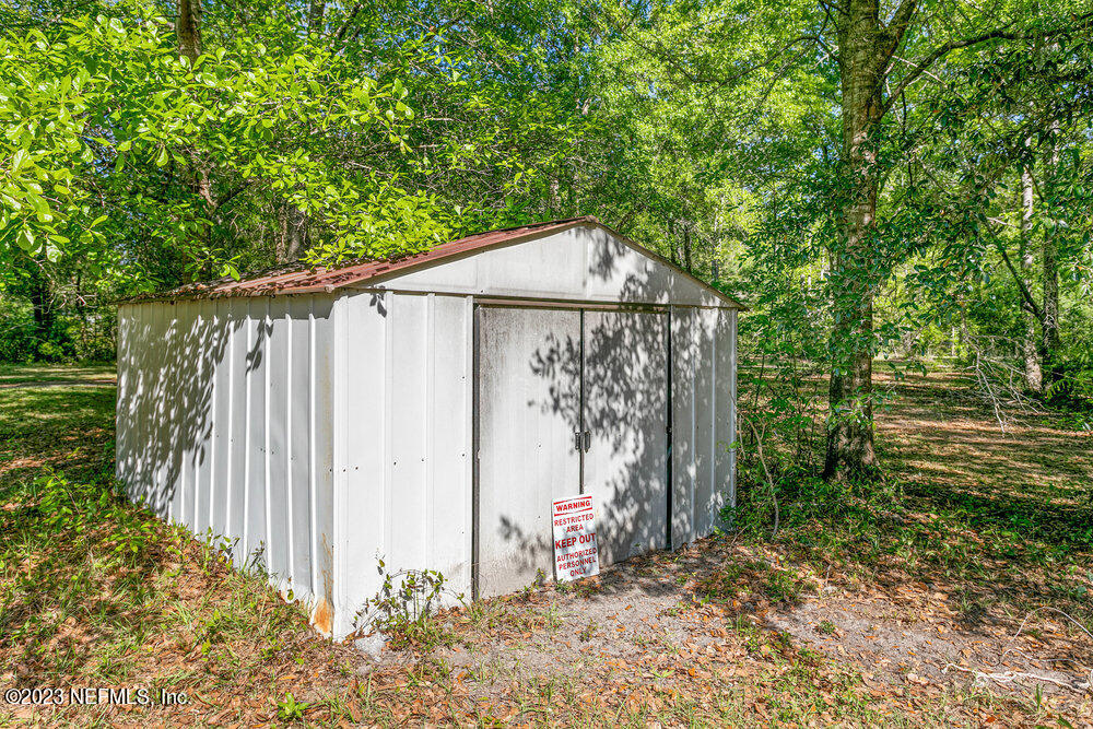 18066 Wells Road Jacksonville, FL 32234 - Photo 39 of 50 a wooden fence with a trees in the background