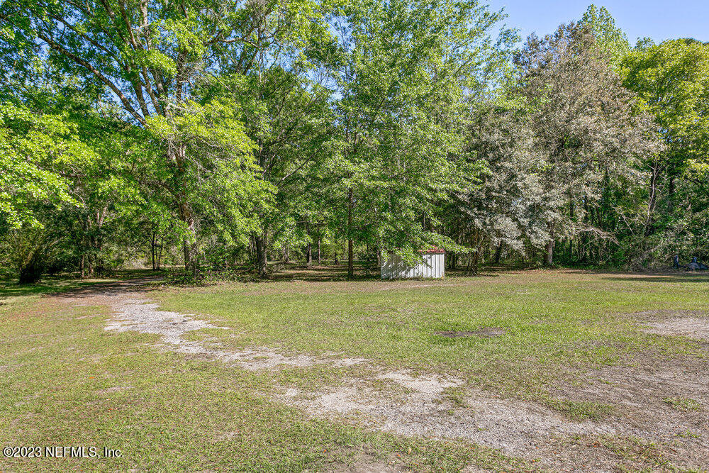18066 Wells Road Jacksonville, FL 32234 - Photo 40 of 50 a view of a field with trees in the background