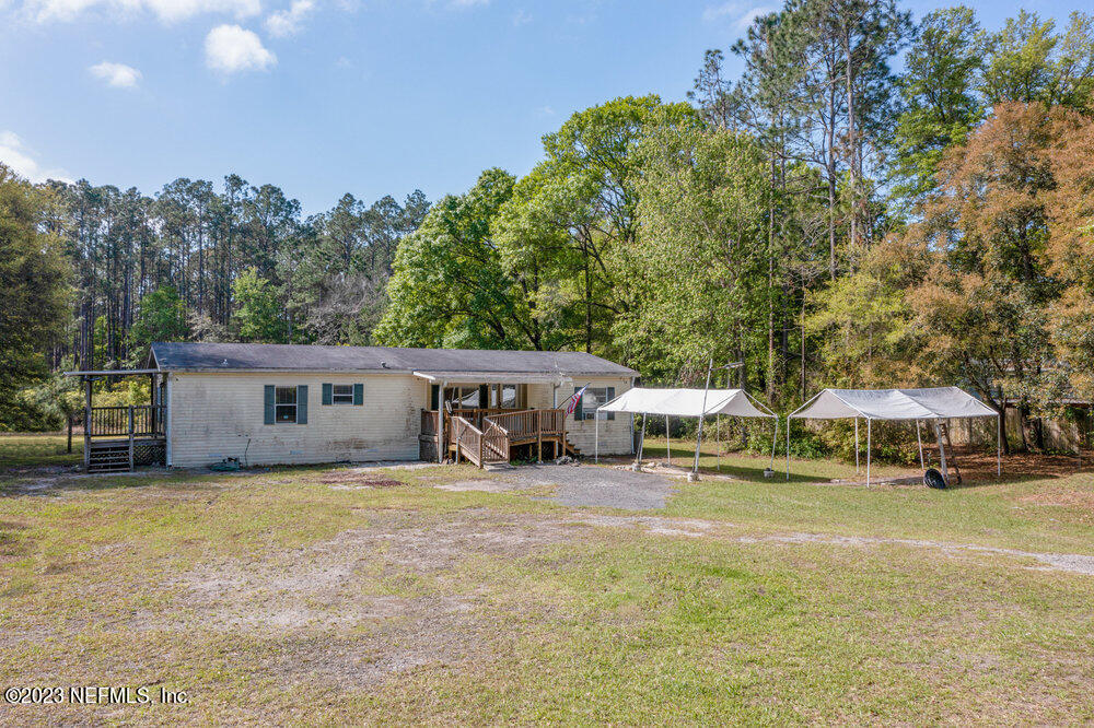 18066 Wells Road Jacksonville, FL 32234 - Photo 42 of 50 a view of a house with outdoor space and trees in the background