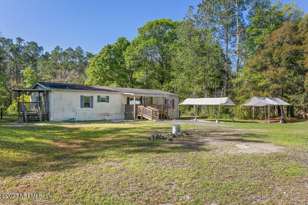 18066 Wells Road Jacksonville, FL 32234 - Photo 7 of 50 a front view of a house with a garden