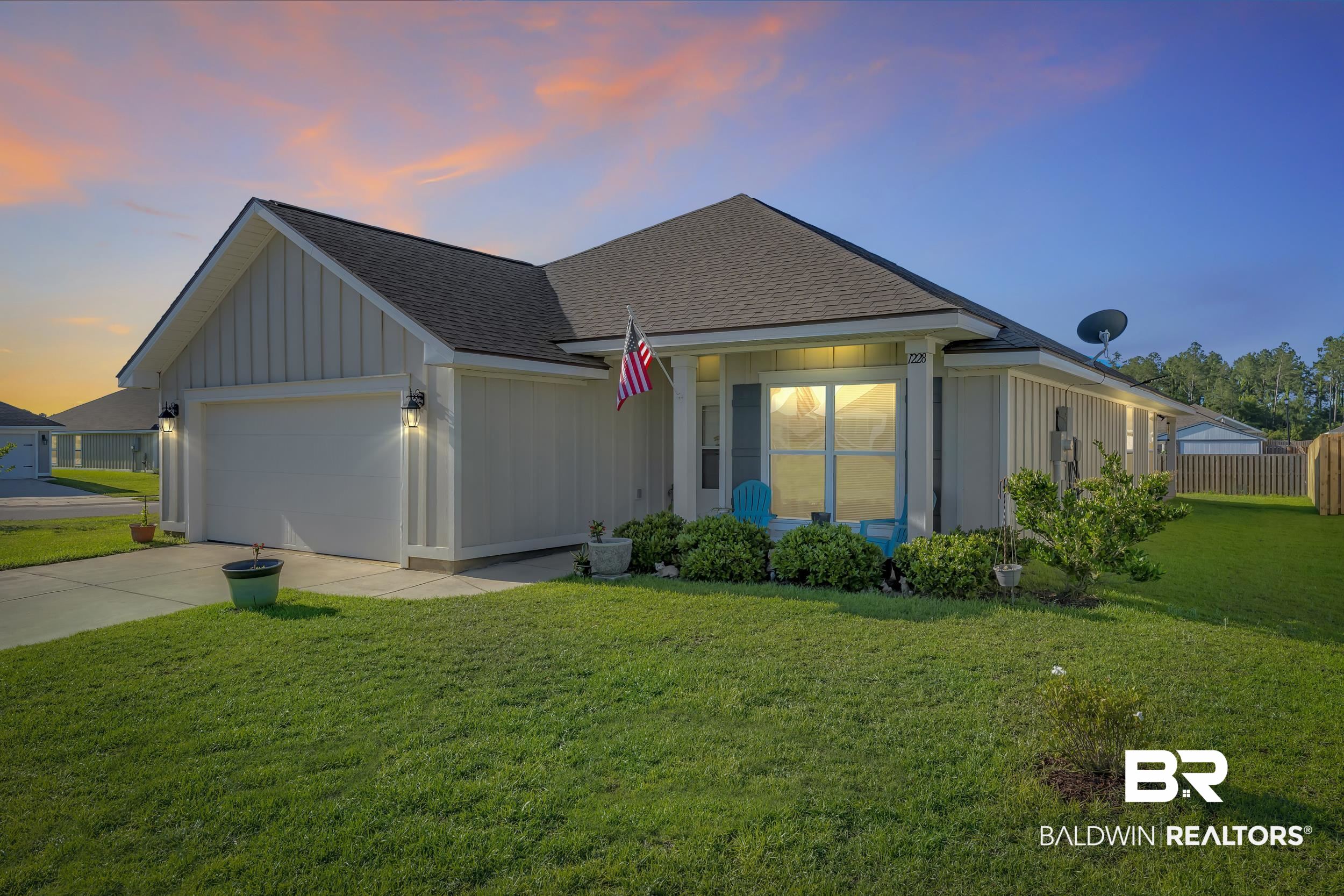 1228 Caper Avenue Foley, AL 36535 - Photo 4 of 54 Single-story residence featuring light-colored vertical siding and a dark shingle roof