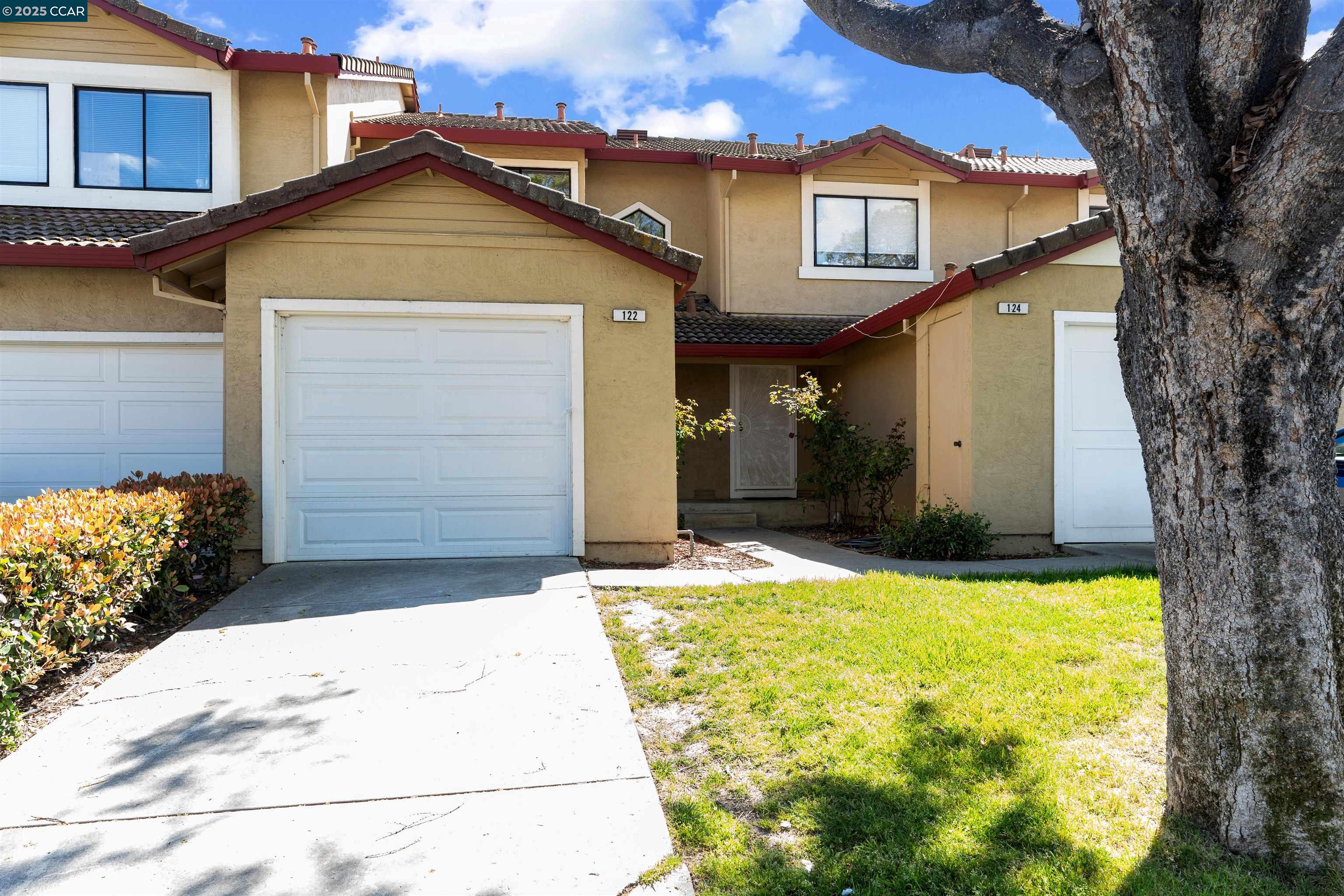 a front view of a house with a yard and garage