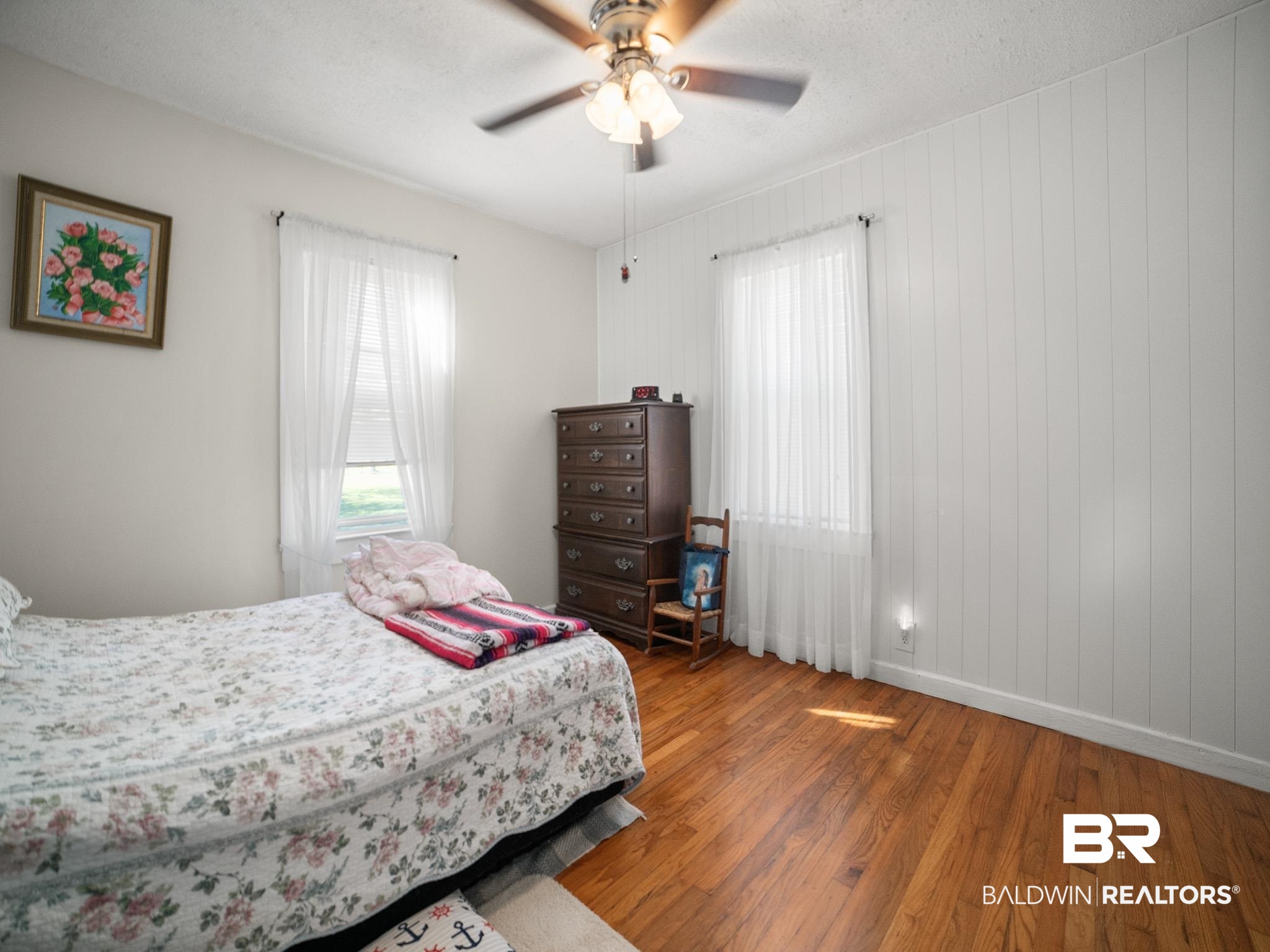 18744 Fairground Road Robertsdale, AL 36567 - Photo 10 of 20 Bedroom featuring hardwood / wood-style floors, a textured ceiling, ceiling fan, and wood walls