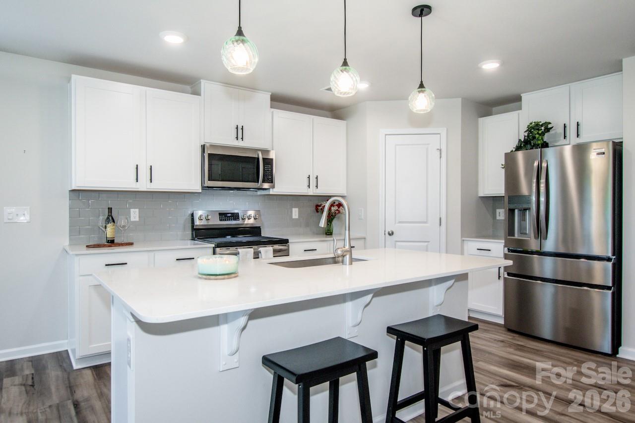 2742 Legacy Ridge Lane Catawba, NC 28609 - Photo 14 of 36 a kitchen with a refrigerator a microwave a stove a sink and a center island