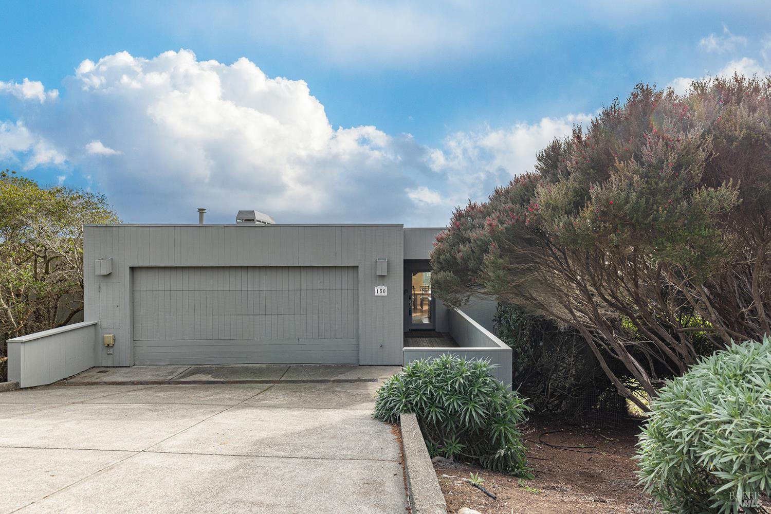 150 Cypress Loop Bodega Bay, CA 94923 - Photo 2 of 62 a front view of a house with a garage