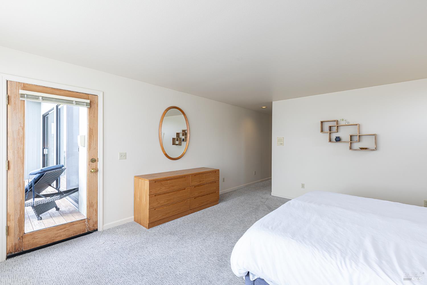 150 Cypress Loop Bodega Bay, CA 94923 - Photo 26 of 62 a bedroom with a bed and a painting on the wall