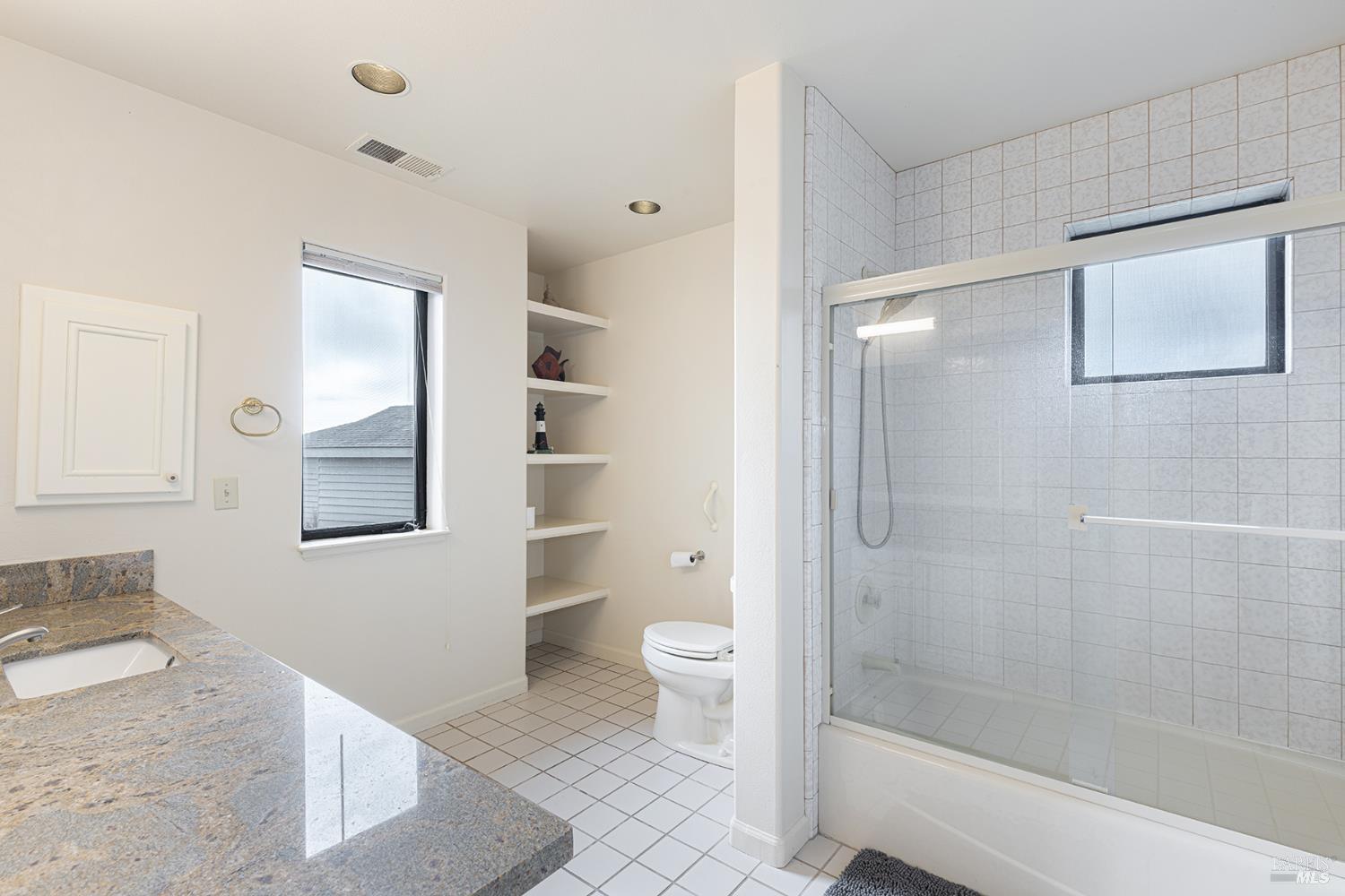 150 Cypress Loop Bodega Bay, CA 94923 - Photo 45 of 62 a bathroom with a granite countertop sink a toilet and shower