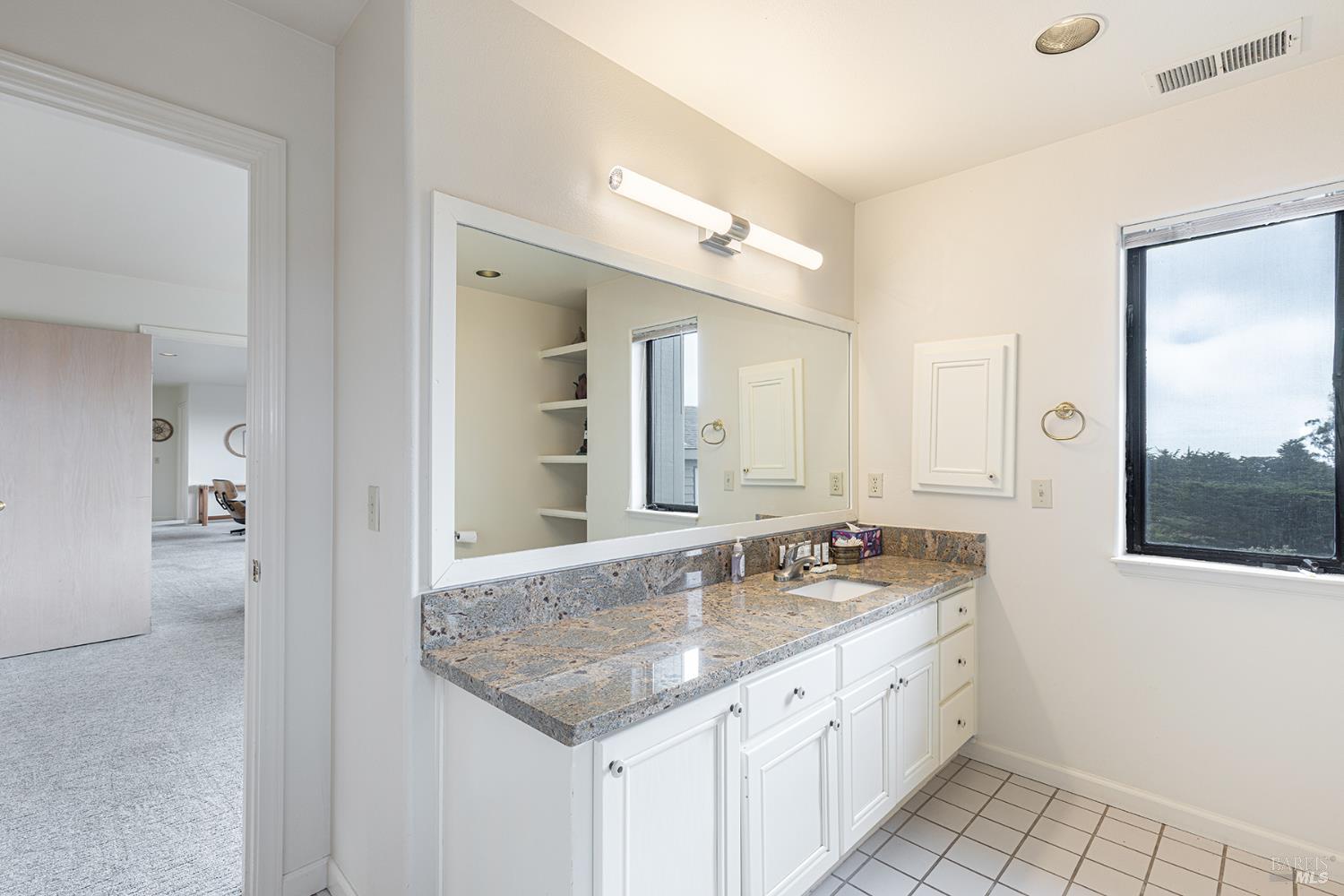 150 Cypress Loop Bodega Bay, CA 94923 - Photo 46 of 62 a bathroom with a granite countertop sink and a mirror
