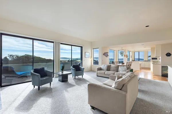 a living room with furniture flat screen tv and a large window