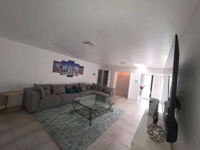 a living room with furniture and a rug