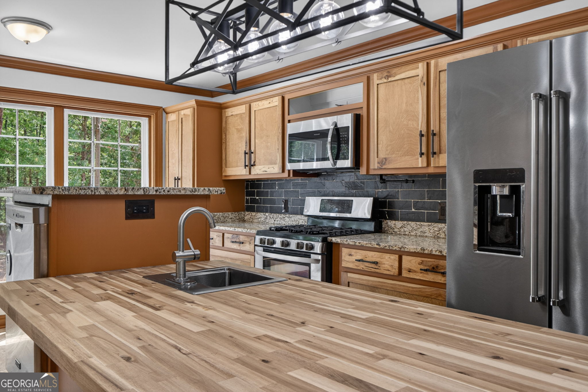 916 Highway 36 Barnesville, GA 30204 - Photo 22 of 81 a kitchen with stainless steel appliances granite countertop a stove and a refrigerator