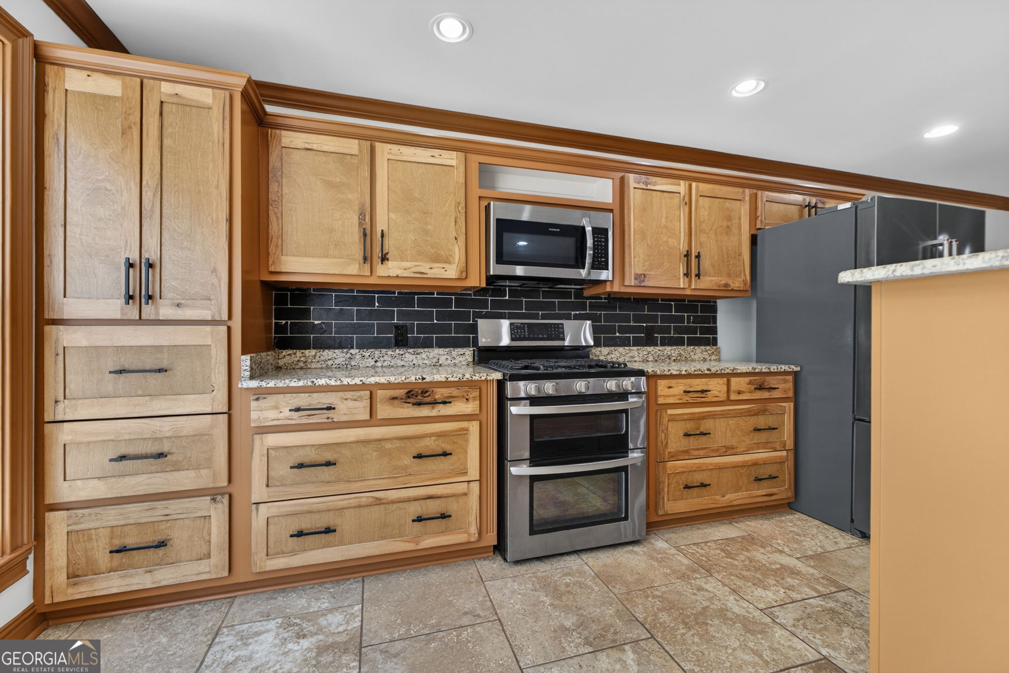 916 Highway 36 Barnesville, GA 30204 - Photo 24 of 81 a kitchen with stainless steel appliances a stove and cabinets