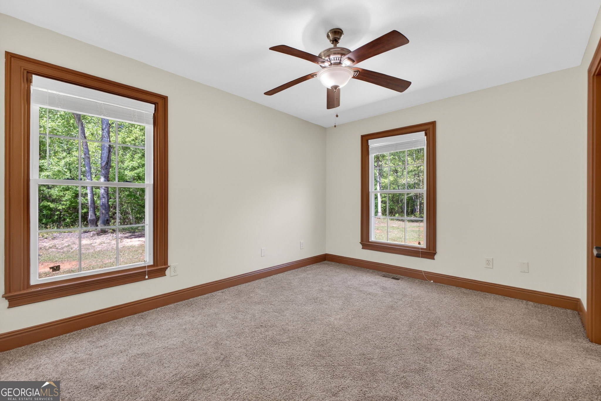 916 Highway 36 Barnesville, GA 30204 - Photo 41 of 81 a view of a big room with windows and chandelier fan
