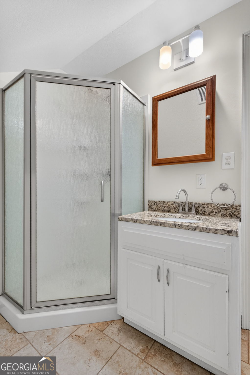 916 Highway 36 Barnesville, GA 30204 - Photo 49 of 81 a bathroom with a granite countertop sink a mirror and a shower