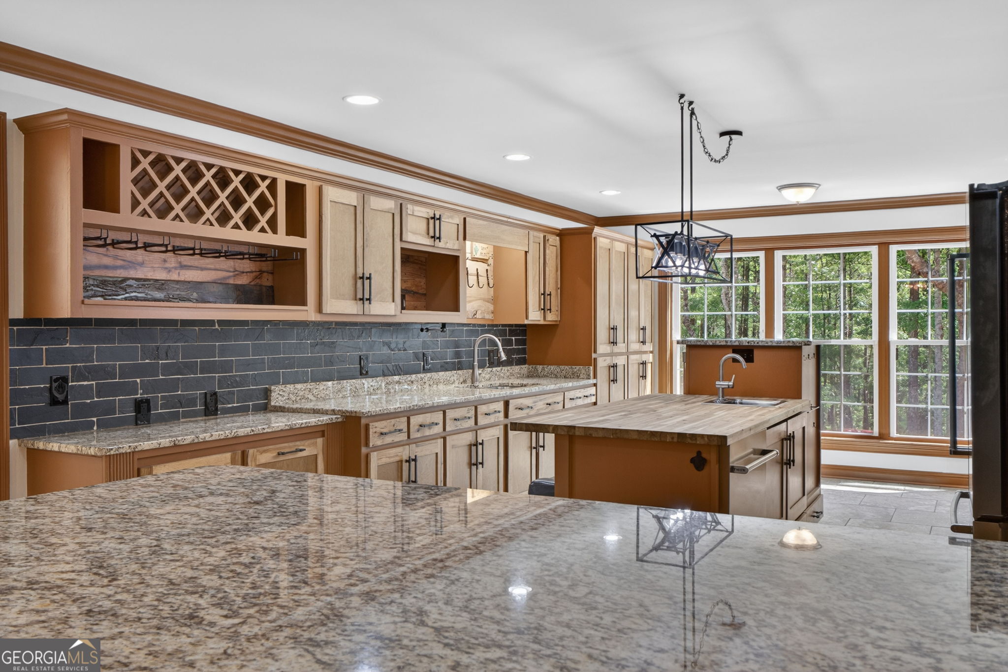 916 Highway 36 Barnesville, GA 30204 - Photo 5 of 81 a kitchen with stainless steel appliances granite countertop a stove top oven a sink a dining table and chairs with wooden floor