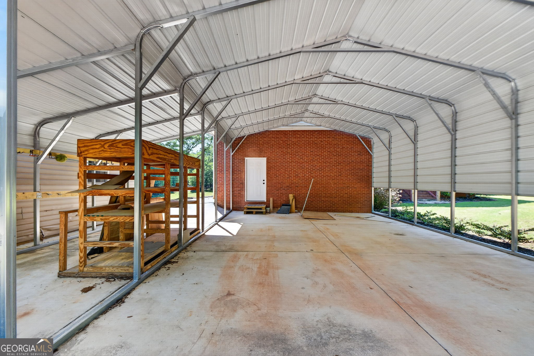 916 Highway 36 Barnesville, GA 30204 - Photo 64 of 81 a view of entrance gate of a building with a bench
