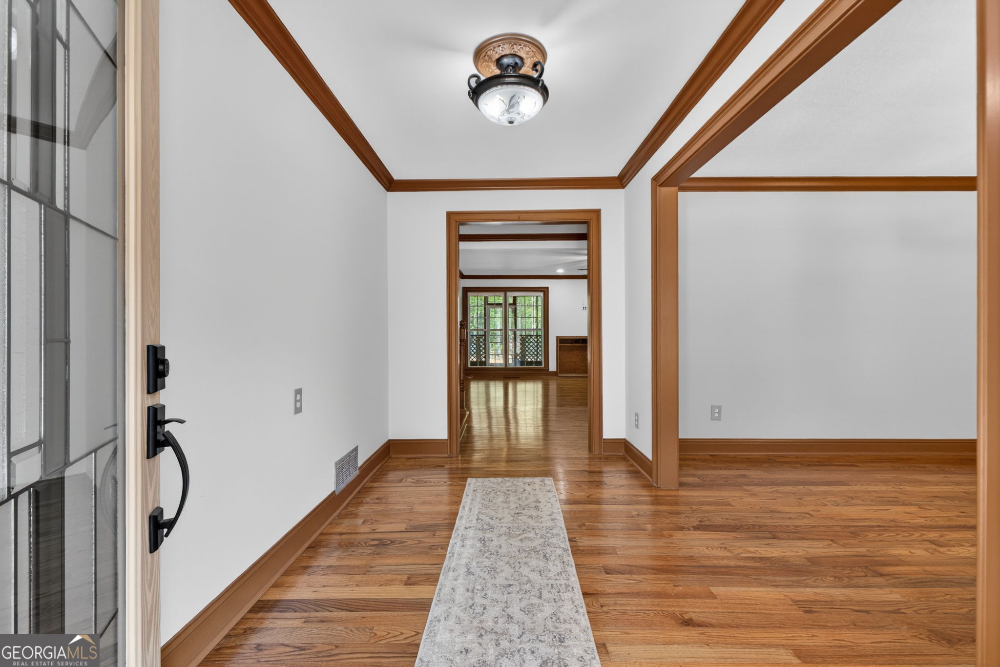 916 Highway 36 Barnesville, GA 30204 - Photo 7 of 81 a view of a hallway with wooden floor and staircase