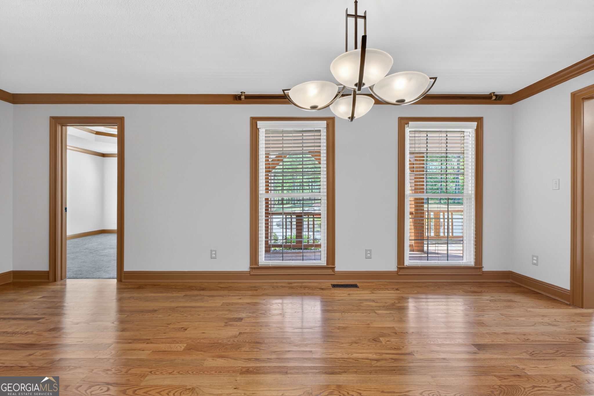 916 Highway 36 Barnesville, GA 30204 - Photo 9 of 81 a view of an empty room with wooden floor and a window