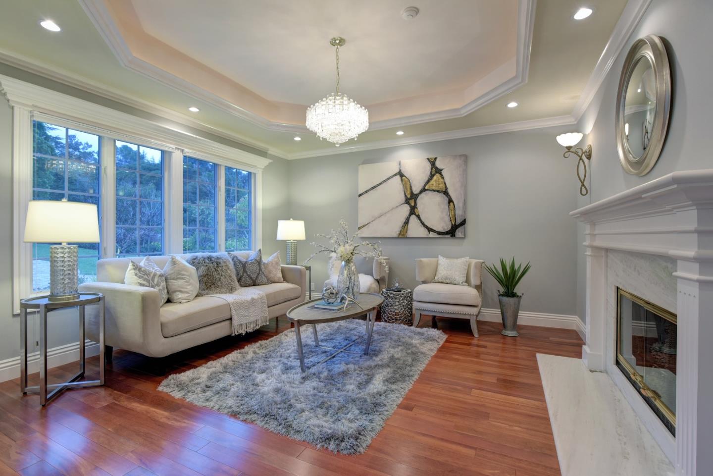 14000 Pike Road Saratoga, CA 95070 - Photo 13 of 48 a living room with furniture a chandelier and a fireplace