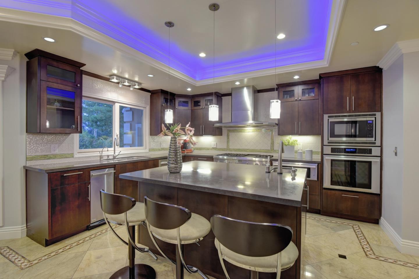 14000 Pike Road Saratoga, CA 95070 - Photo 17 of 48 a kitchen with kitchen island granite countertop a sink stainless steel appliances and chairs