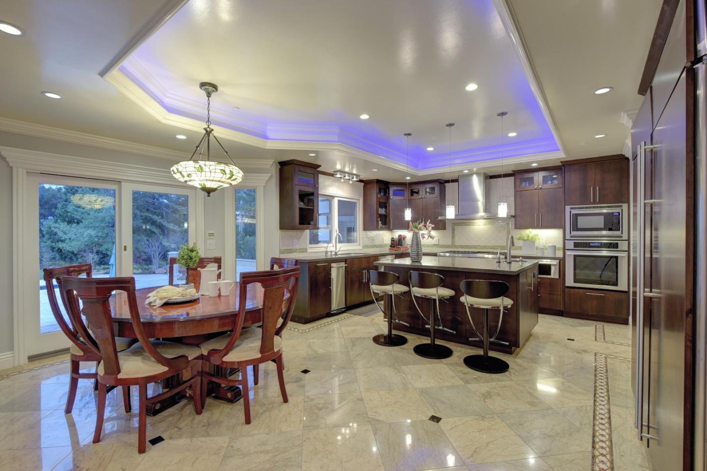 14000 Pike Road Saratoga, CA 95070 - Photo 19 of 48 a dining room with stainless steel appliances kitchen island granite countertop a dining table chairs and a refrigerator