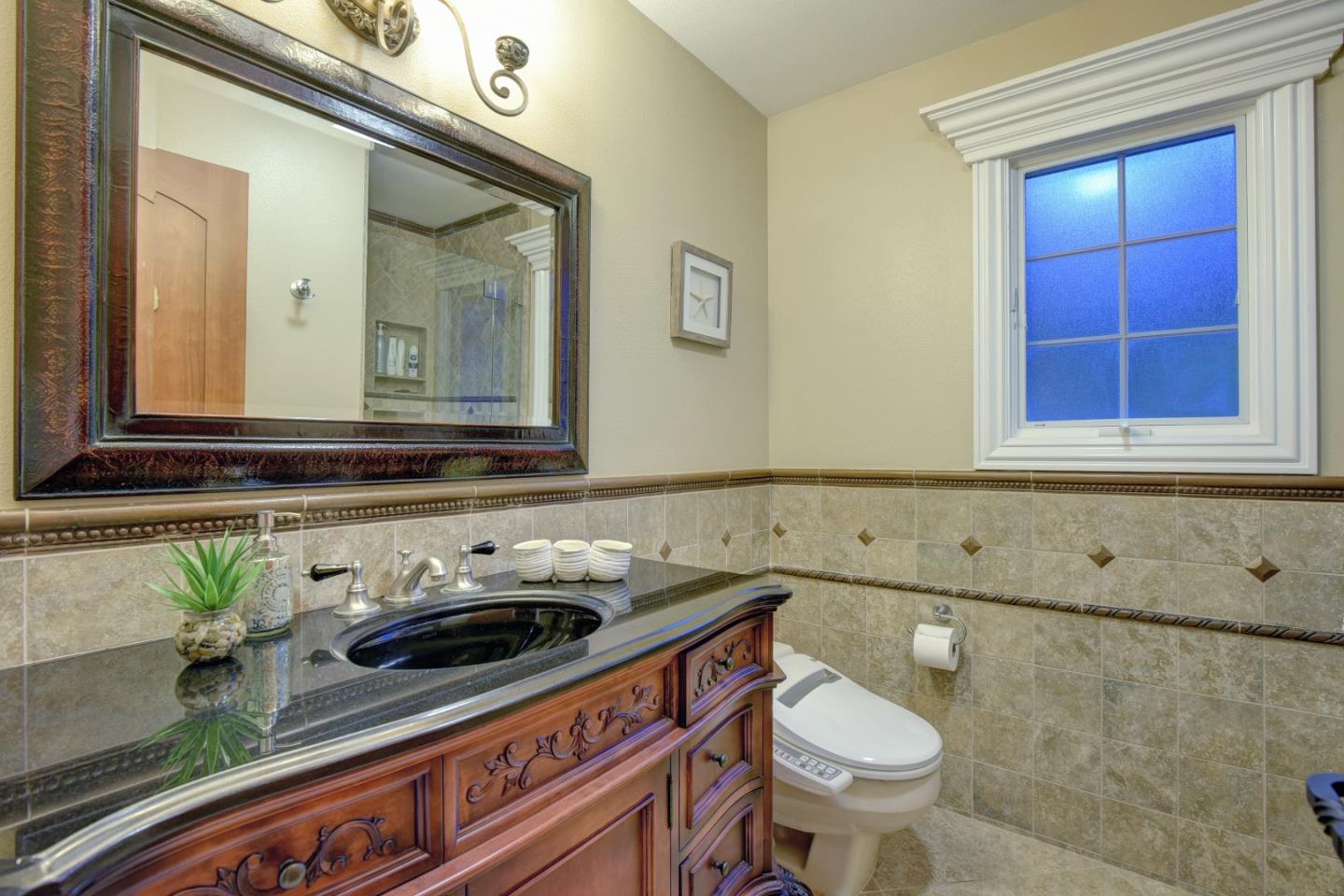 14000 Pike Road Saratoga, CA 95070 - Photo 27 of 48 a bathroom with a sink a toilet and mirror