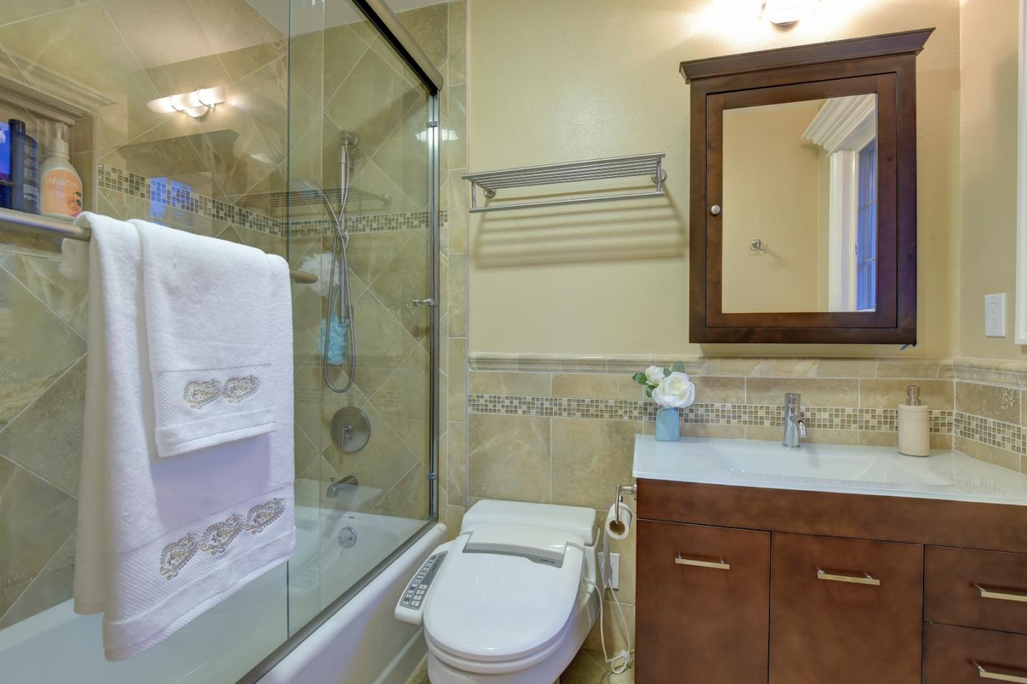 14000 Pike Road Saratoga, CA 95070 - Photo 31 of 48 a bathroom with a granite countertop toilet sink and mirror