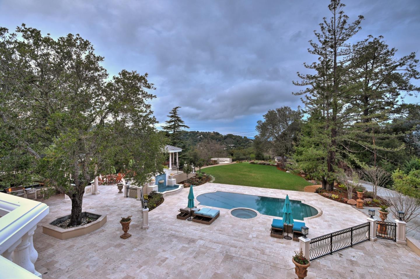 14000 Pike Road Saratoga, CA 95070 - Photo 36 of 48 a view of a swimming pool with lawn chairs and a fire pit