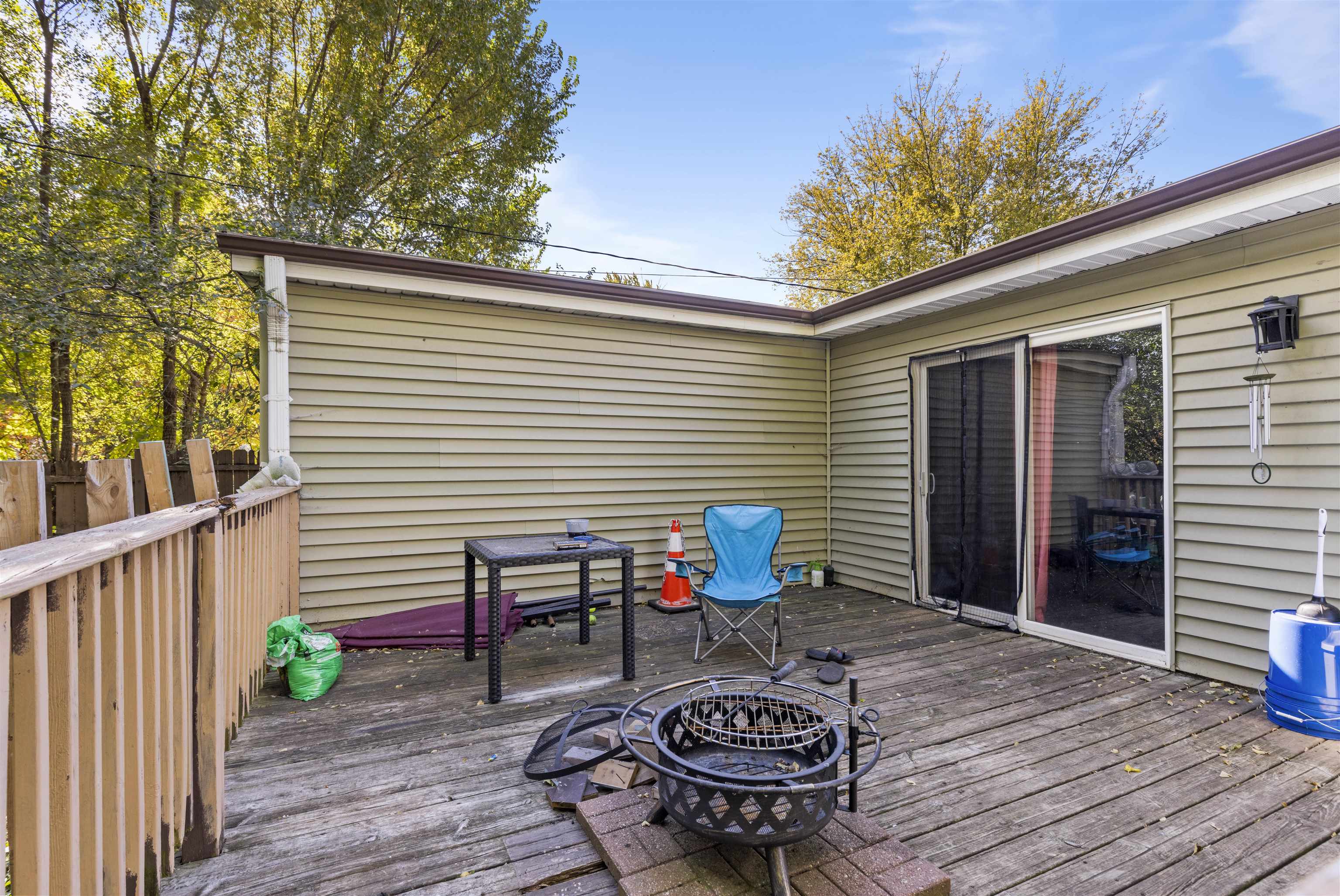 907 Woolf Court Rochelle, IL 61068 - Photo 14 of 15 a table and chairs in front of a house