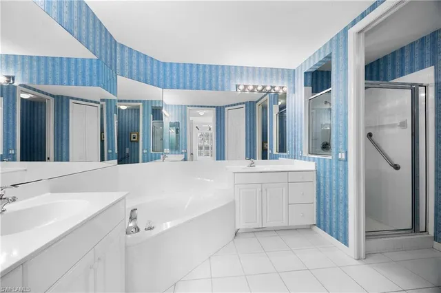 a spacious bathroom with a sink a mirror and a bathtub