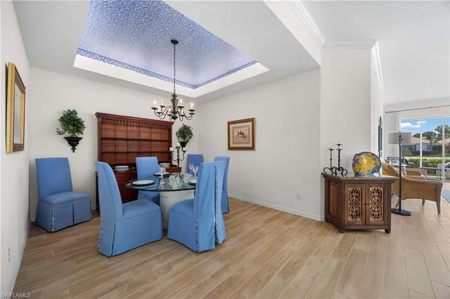 a view of a dining room with furniture wooden floor and chandelier