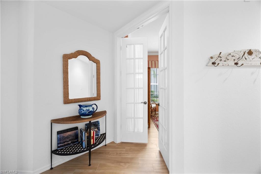 1826 Seville Boulevard, Unit 1012 Naples, FL 34109 - Photo 19 of 50 a view of an entryway with wooden floor